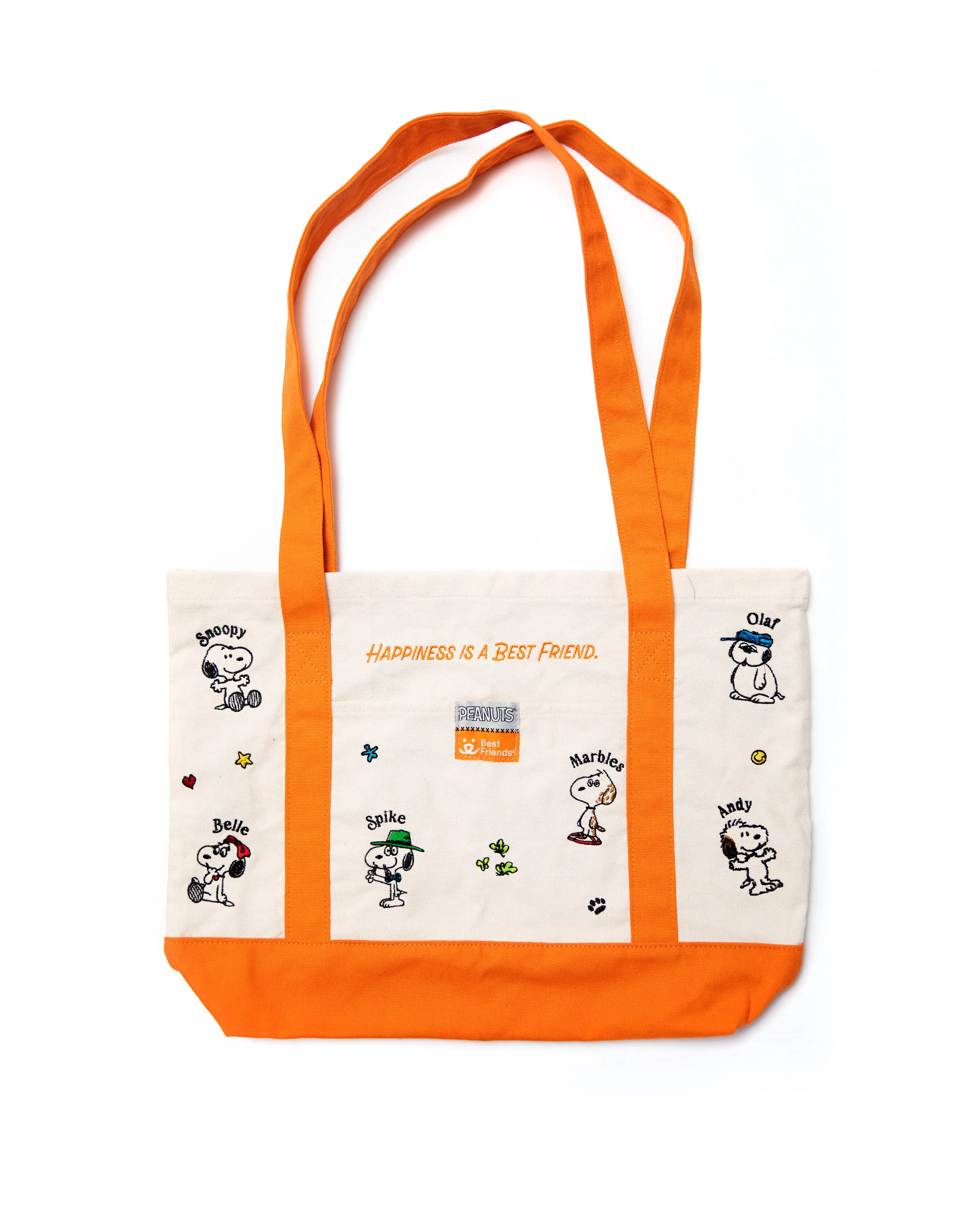 Cream canvas tote bag with orange straps and base, decorated with Peanuts characters.